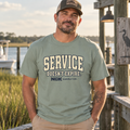 A man wearing a sage green t-shirt with 'SERVICE DOESN'T EXPIRE. NGK SUPPLY CO.